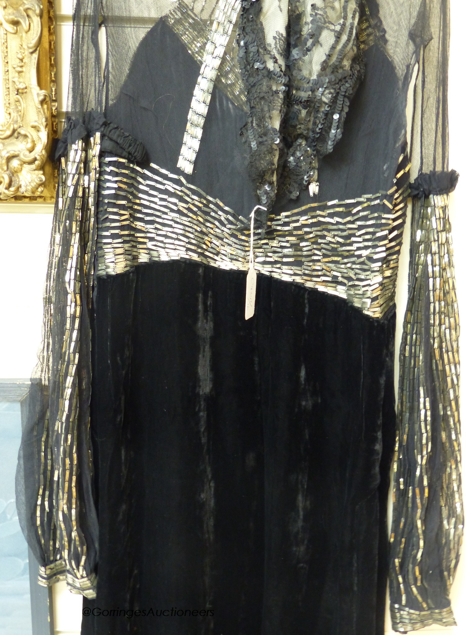 A late 1930's black silk velvet and silver evening dress and an Edwardian black sequin triangular shawl